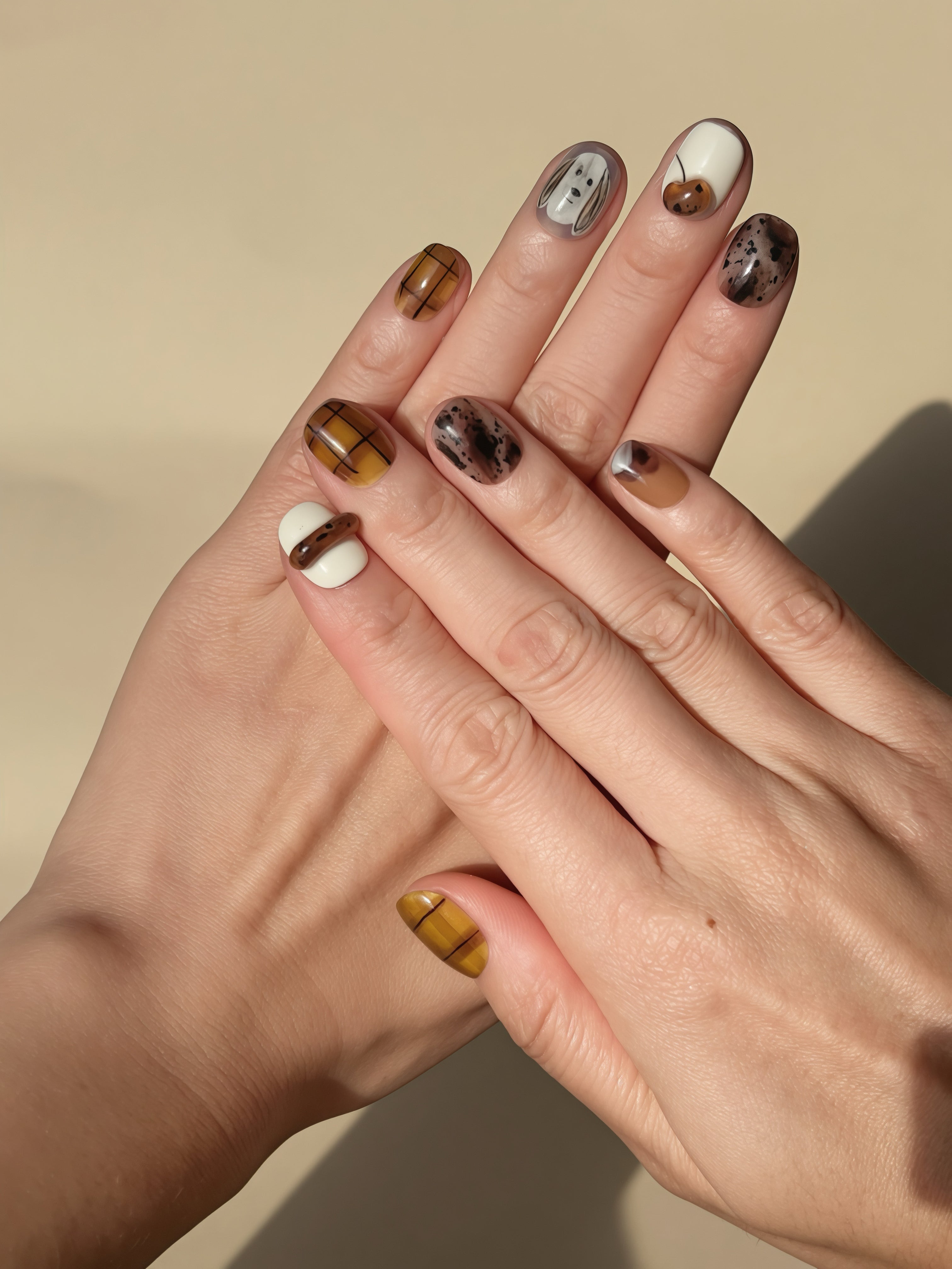 Model wearing Sketchy Puppy press-on nails featuring brown plaid, puppy doodles, and autumn accents
