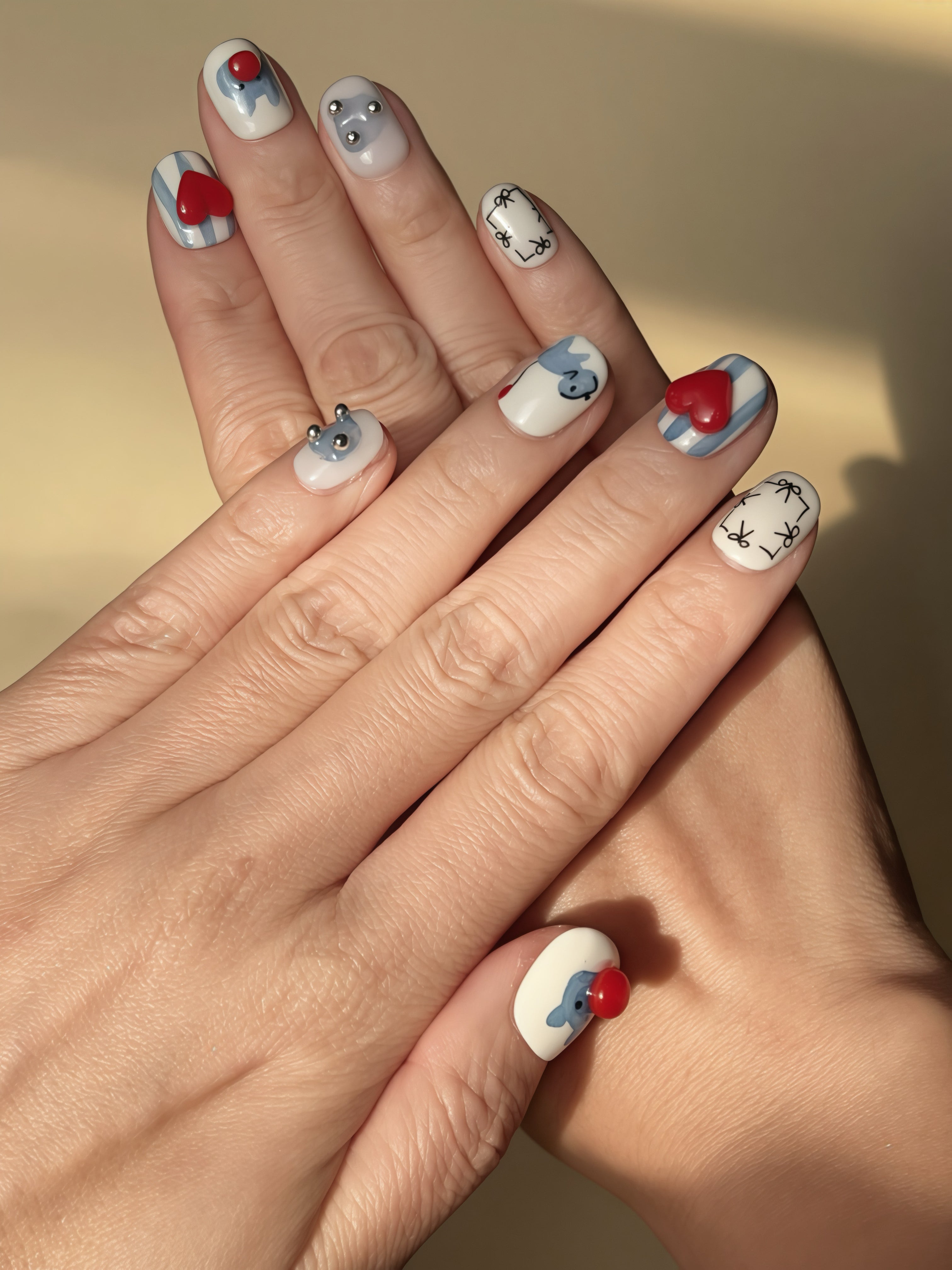Balloon Buddy press-on nails with 3D red heart, stripes, and puppy illustrations