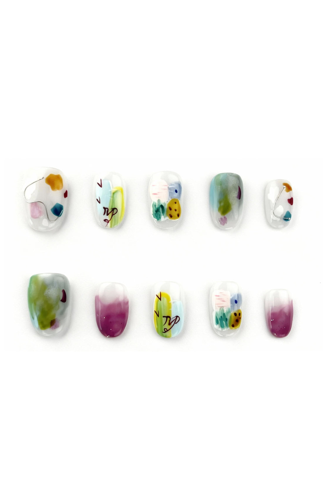 Dreamy Grove press-on nails flatlay showing lilac, blue, green watercolor patterns