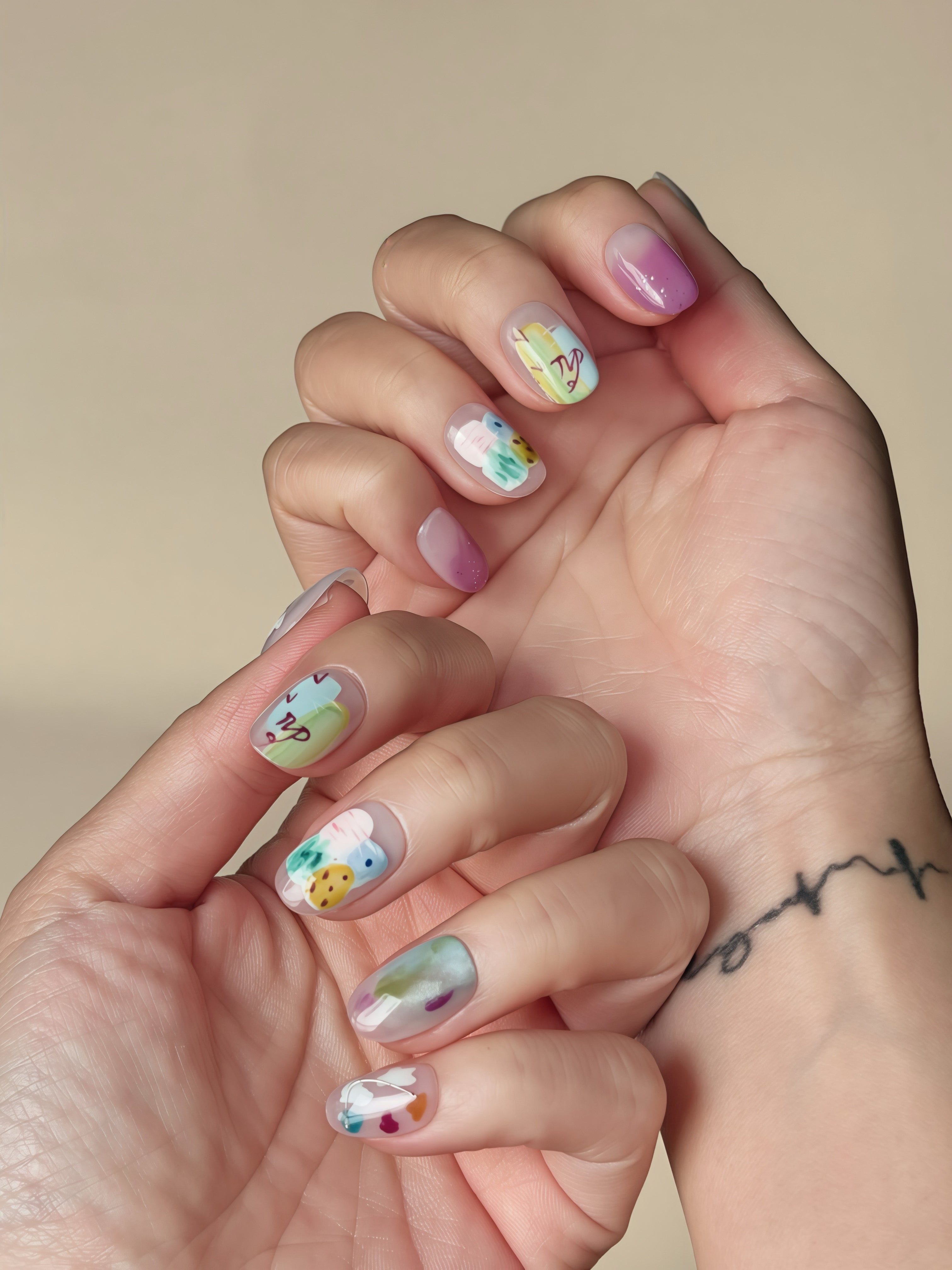 Close-up of Dreamy Grove press-on nails featuring lilac tones, green strokes, and abstract art