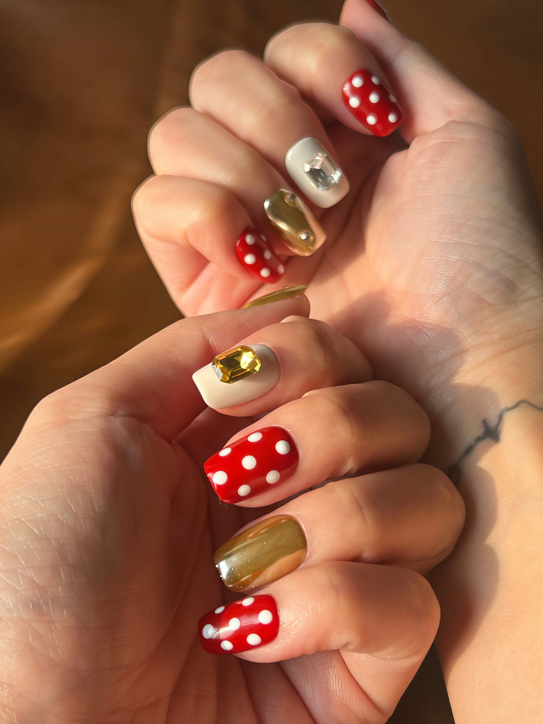 Berry Dots red and gold handmade press-on nails with polka dots and 3D gems — reusable nail art by Momento.