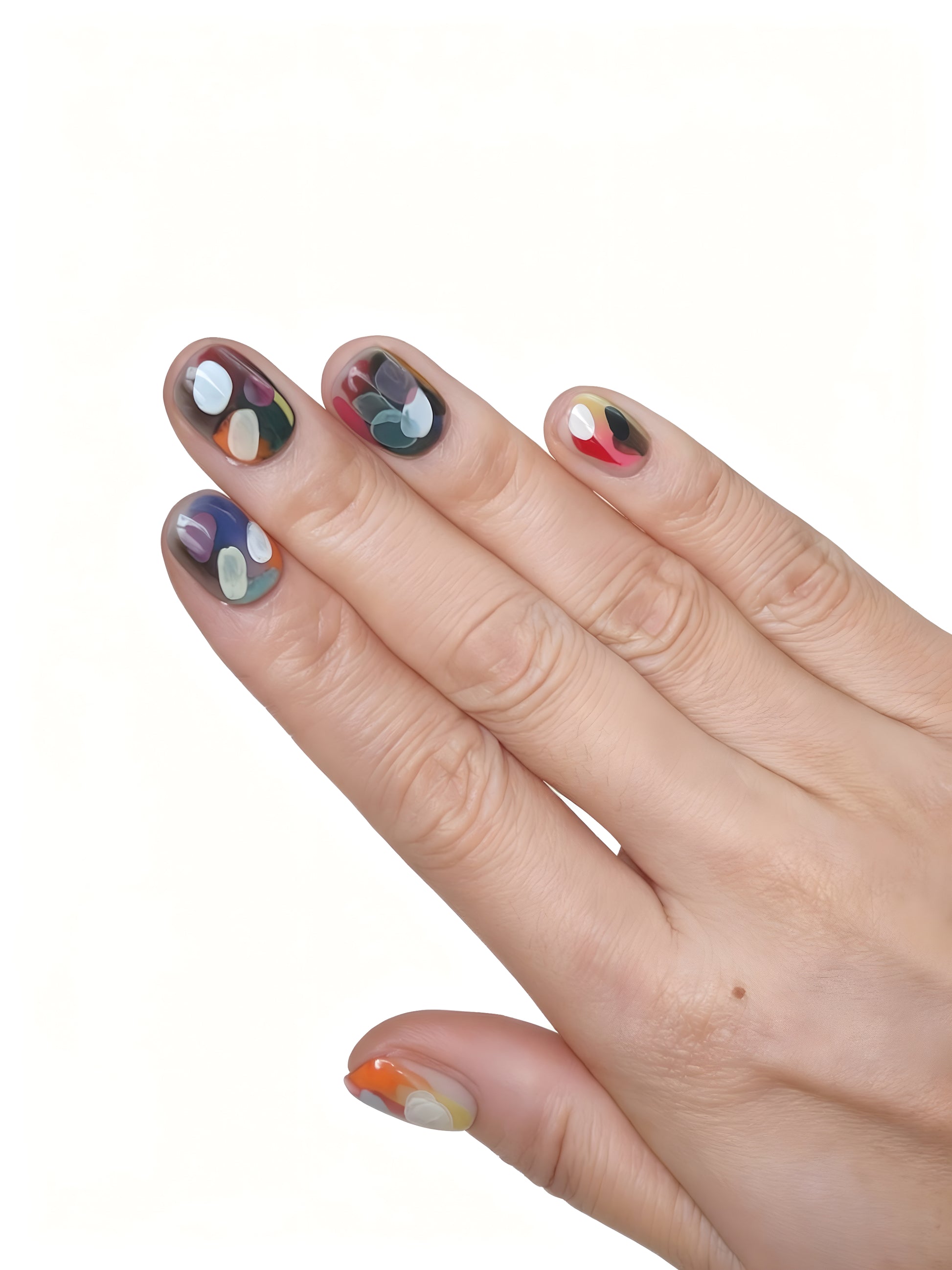Hand pose showing Dopamine Crush press-on nails with colorful abstract patterns blending lilac, teal, red, yellow, and black.