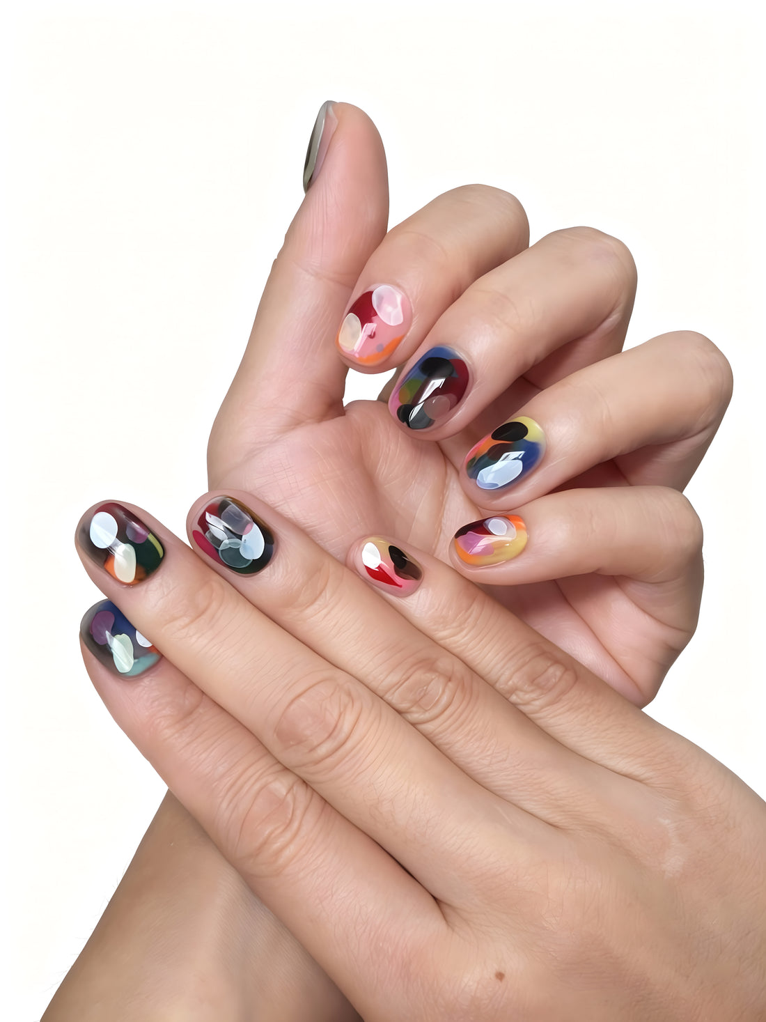 Dopamine Crush press-on nails flatlay showing colorful abstract designs with orange, lilac, yellow, and blue brushstroke patterns by Momento.