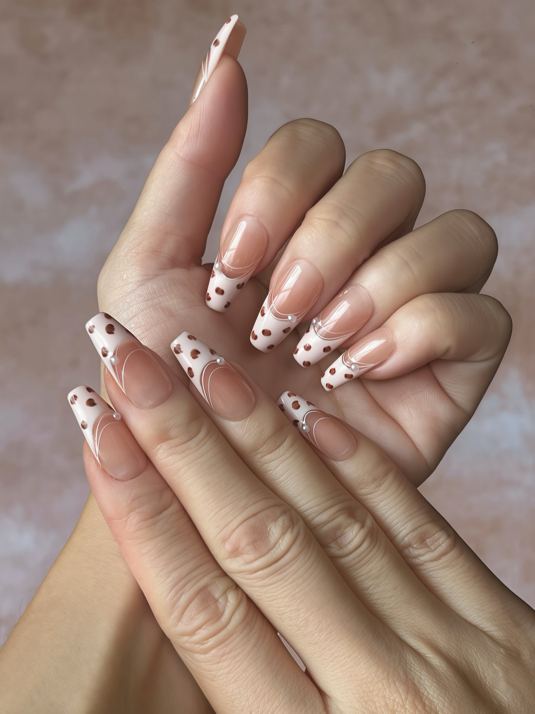 Gentle Wild press-on nails flatlay featuring blush-pink French tips with deep red leopard spots and tiny pearl details.