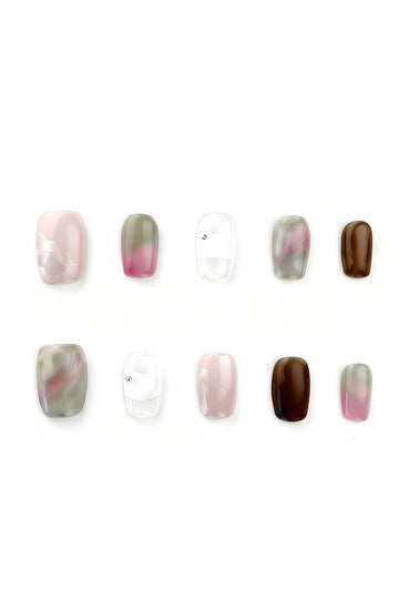 Peony Mist press-on nail set flatlay showing watercolor pink, brown, teal, and white designs by Momento Nails.