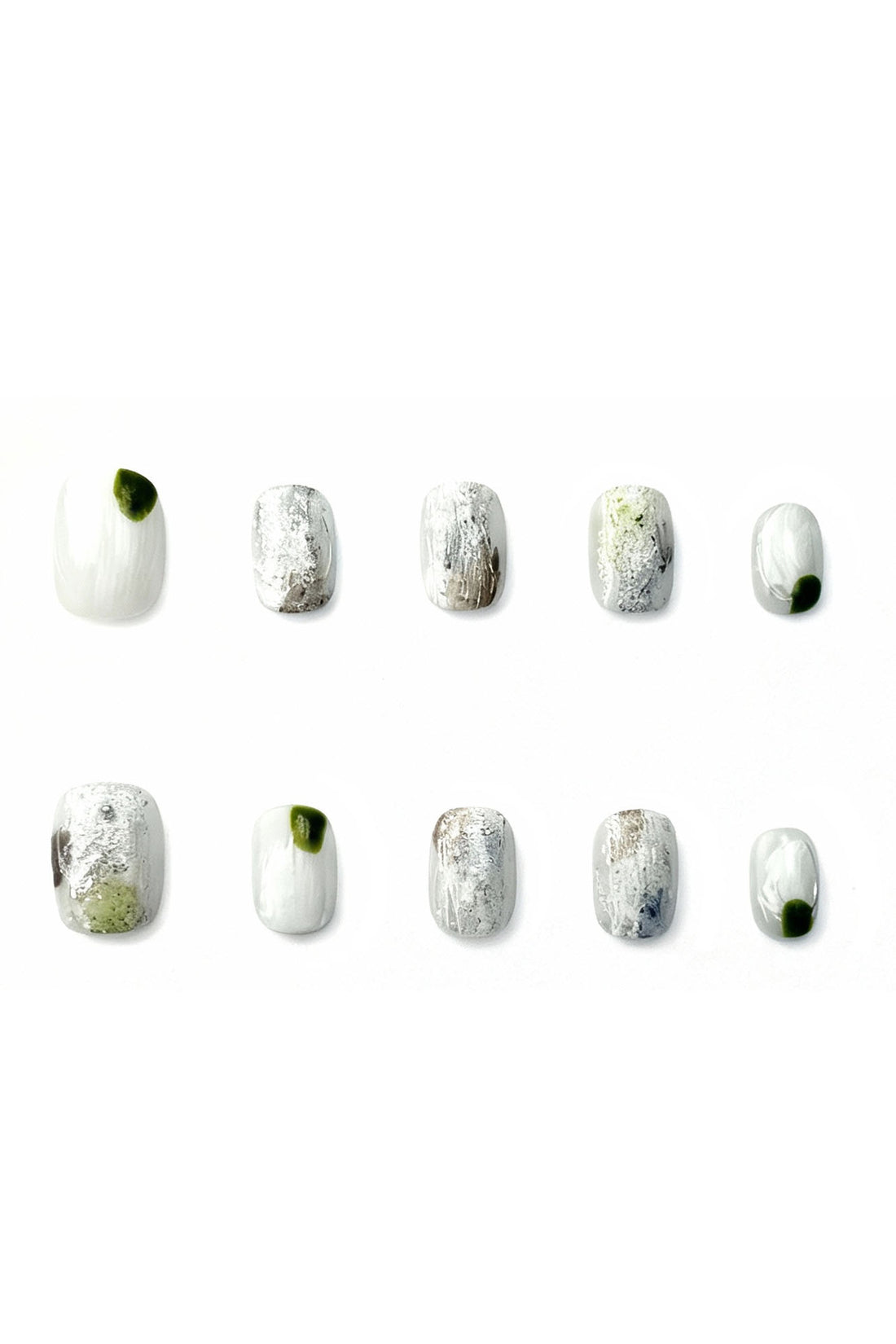 Moss Whisper press-on nails flatlay — white and silver textured nails with moss-green accent, reusable salon-quality press-on nails by Momento.