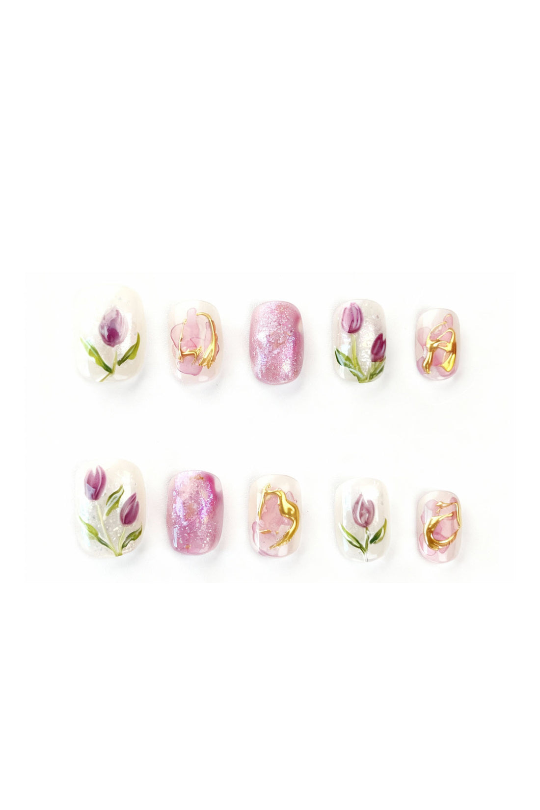 Flatlay of Tulip Reverie press-on nails with pink and purple tulip floral designs and pearlescent accents